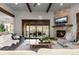 Bright living room with stone fireplace, hardwood floors, and scenic views at 8246 Raphael Ln, Littleton, CO 80125