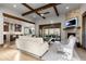 Inviting living room with wooden beams, stone fireplace, and seamless access to outdoor space at 8246 Raphael Ln, Littleton, CO 80125