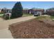 Cozy home with a long driveway leading to an attached garage, with mature landscaping at 9008 Dover St, Broomfield, CO 80021