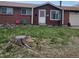 Charming brick home featuring a well-manicured lawn and inviting front entrance at 9008 Dover St, Broomfield, CO 80021