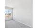 Bedroom featuring gray carpet, white walls and trim, and large window for natural light at 1312 Sienna Peak Cir, Erie, CO 80516