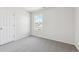 Bedroom with gray carpet, white walls and trim, and natural light from the window at 1312 Sienna Peak Cir, Erie, CO 80516