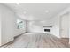 Bright living room featuring hardwood floors, a modern fireplace, and ample natural light from large windows at 1312 Sienna Peak Cir, Erie, CO 80516