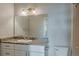 Bathroom vanity with granite countertop, white cabinets, and a large mirror at 14251 E 1St Dr # 308, Aurora, CO 80011