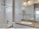 A bathroom featuring tile shower-tub and granite countertop vanity with modern fixtures at 14251 E 1St Dr # 308, Aurora, CO 80011