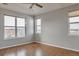This bedroom features hardwood floors, neutral walls, and three bright windows with views at 14251 E 1St Dr # 308, Aurora, CO 80011