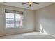 Bedroom features carpet, large window with blinds and natural light with a ceiling fan at 14251 E 1St Dr # 308, Aurora, CO 80011