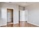 A bedroom featuring hardwood floors and an open closet with a built-in shelving system at 14251 E 1St Dr # 308, Aurora, CO 80011