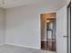 Light and airy bedroom with ensuite bathroom featuring hardwood floors, an open door, and neutral walls at 14251 E 1St Dr # 308, Aurora, CO 80011