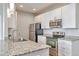 Updated kitchen features stainless steel appliances, granite countertops, and ample cabinet space at 14251 E 1St Dr # 308, Aurora, CO 80011