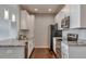 Kitchen with white cabinets, stainless steel appliances, and granite countertops at 14251 E 1St Dr # 308, Aurora, CO 80011