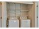 Well-organized laundry room with washer, dryer, and wire shelving at 14251 E 1St Dr # 308, Aurora, CO 80011