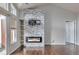Living room with fireplace and side shelves, and access to balcony at 14251 E 1St Dr # 308, Aurora, CO 80011