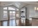 Bright living room with modern fireplace, mounted TV, hardwood floors, and balcony access at 14251 E 1St Dr # 308, Aurora, CO 80011