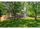 Spacious backyard featuring a large shade tree, lush lawn, and covered patio at 5625 W 109Th Cir, Westminster, CO 80020
