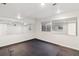 Basement featuring black flooring, white walls, mirrors, and windows at 5625 W 109Th Cir, Westminster, CO 80020