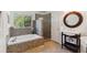 This bathroom features a stand alone tub, glass shower, and single sink at 5625 W 109Th Cir, Westminster, CO 80020