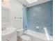 This bathroom features blue tiled walls, a shower/tub, and a skylight at 5625 W 109Th Cir, Westminster, CO 80020