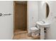 Neutral toned bathroom featuring a tiled shower, toilet, and pedestal sink at 5625 W 109Th Cir, Westminster, CO 80020