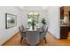 Elegant dining room with wood floors, modern lighting, and seating for eight guests at 5625 W 109Th Cir, Westminster, CO 80020