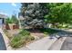Desirable home featuring an expansive lawn, mature trees, and manicured garden beds at 5625 W 109Th Cir, Westminster, CO 80020