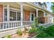 Charming covered porch with brick columns and a flower garden offers an inviting entrance at 5625 W 109Th Cir, Westminster, CO 80020