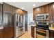 Kitchen featuring stainless steel appliances, a breakfast bar, and hardwood floors at 5625 W 109Th Cir, Westminster, CO 80020