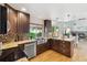 Well-lit kitchen with stainless steel appliances, granite counters, and a view into the living room at 5625 W 109Th Cir, Westminster, CO 80020