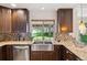 Kitchen with a stainless steel sink, granite counters, and a backyard view at 5625 W 109Th Cir, Westminster, CO 80020