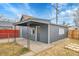 Backyard features a detached garage, gray siding, and fencing at 3368 W Gill Pl, Denver, CO 80219