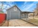 Backyard features a detached garage, gray siding, and concrete driveway at 3368 W Gill Pl, Denver, CO 80219