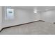Finished basement with large window, neutral carpet, and closet at 3368 W Gill Pl, Denver, CO 80219