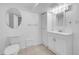 Well-lit basement bathroom features a toilet, sink, and mirror at 3368 W Gill Pl, Denver, CO 80219