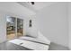 Bright bedroom features a sliding glass door leading to a wooden deck at 3368 W Gill Pl, Denver, CO 80219