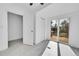 Bright bedroom features a sliding glass door leading to a wooden deck and a closet at 3368 W Gill Pl, Denver, CO 80219