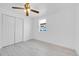 This bedroom includes a ceiling fan, closet, and a window that provides natural light at 3368 W Gill Pl, Denver, CO 80219
