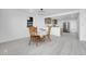 Comfortable dining area with a view of the modern kitchen, featuring matching wooden chairs and clean white walls at 3368 W Gill Pl, Denver, CO 80219