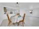 Inviting dining space with classic wooden furniture, stylish light fixtures, and a seamless connection to the kitchen at 3368 W Gill Pl, Denver, CO 80219