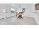 Charming dining room bathed in natural light, showcasing updated floors and a view into the adjacent kitchen area at 3368 W Gill Pl, Denver, CO 80219