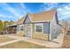 Cozy single-story residence with a stone foundation, matching siding, and a practical carport on a sunny day at 3368 W Gill Pl, Denver, CO 80219