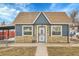 Charming single-story home with a combination of stone and siding facade, complemented by a well-maintained front yard at 3368 W Gill Pl, Denver, CO 80219