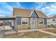 Quaint single-story home featuring stone accents, siding, and a convenient carport for covered parking at 3368 W Gill Pl, Denver, CO 80219
