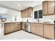 Bright kitchen features stainless steel appliances, quartz countertops, and light wood cabinetry at 3368 W Gill Pl, Denver, CO 80219