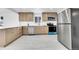 Bright kitchen features stainless steel appliances, quartz countertops, and light wood cabinetry at 3368 W Gill Pl, Denver, CO 80219