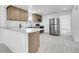 Bright kitchen features stainless steel appliances, quartz countertops, and light wood cabinetry at 3368 W Gill Pl, Denver, CO 80219