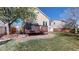 Spacious backyard with stone patio and lush lawn, surrounded by trees and well-maintained landscaping at 11836 Columbine St, Thornton, CO 80233