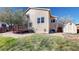 Charming backyard with a wooden deck, green grass, a storage shed and beautiful flowering trees at 11836 Columbine St, Thornton, CO 80233