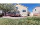 Lovely backyard features a wooden deck, stone patio, grassy lawn, and charming storage shed at 11836 Columbine St, Thornton, CO 80233