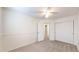 Bright bedroom featuring a ceiling fan, closet, and neutral carpeting at 11836 Columbine St, Thornton, CO 80233
