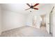 Spacious bedroom showing en-suite bath, ceiling fan and neutral carpeting at 11836 Columbine St, Thornton, CO 80233